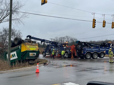 A natural gas powered garbage truck rolls over in Webster Township