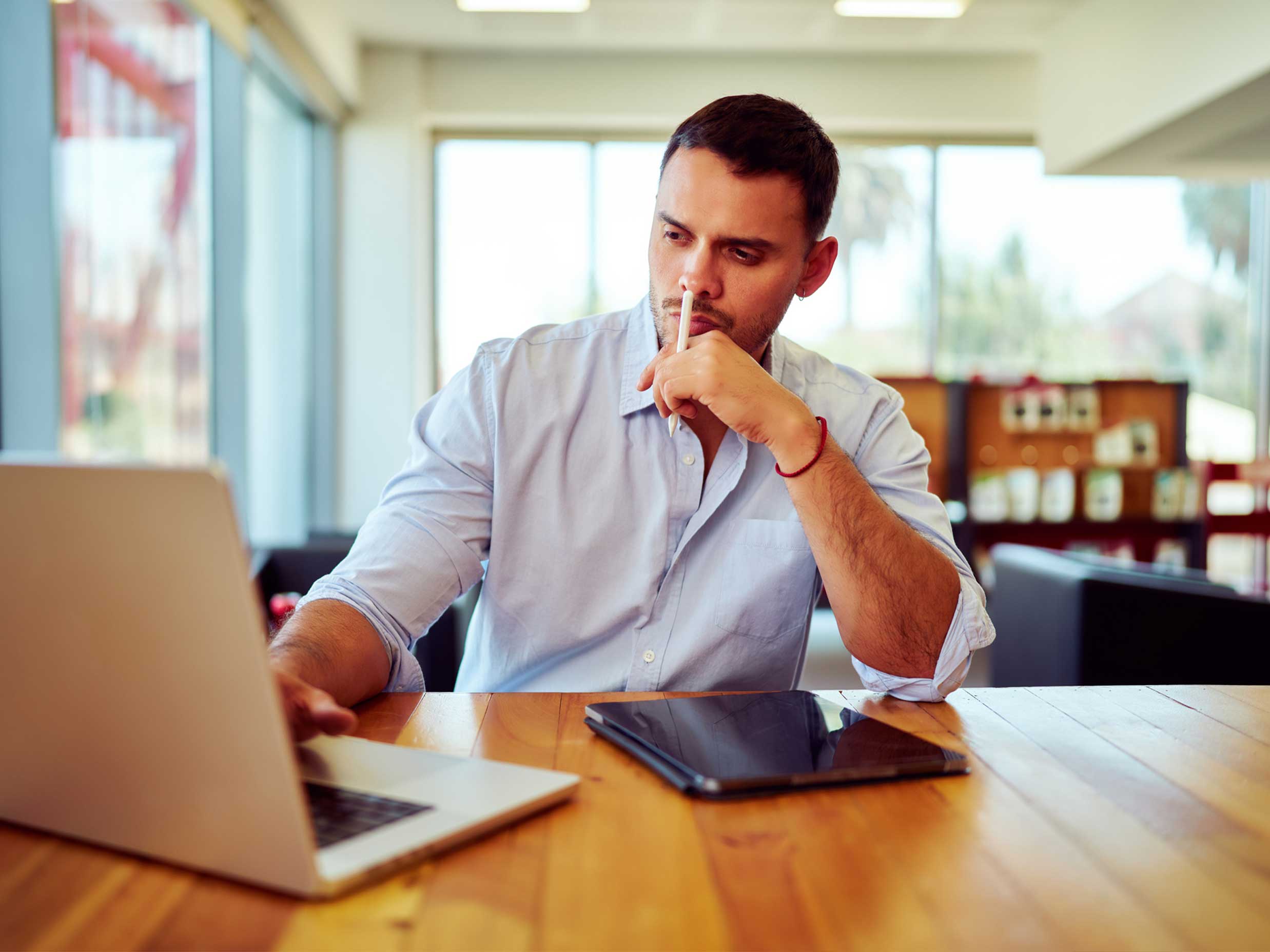 Man researching which business structure to choose from on his laptop.