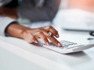 Person calculating business insurance costs.
