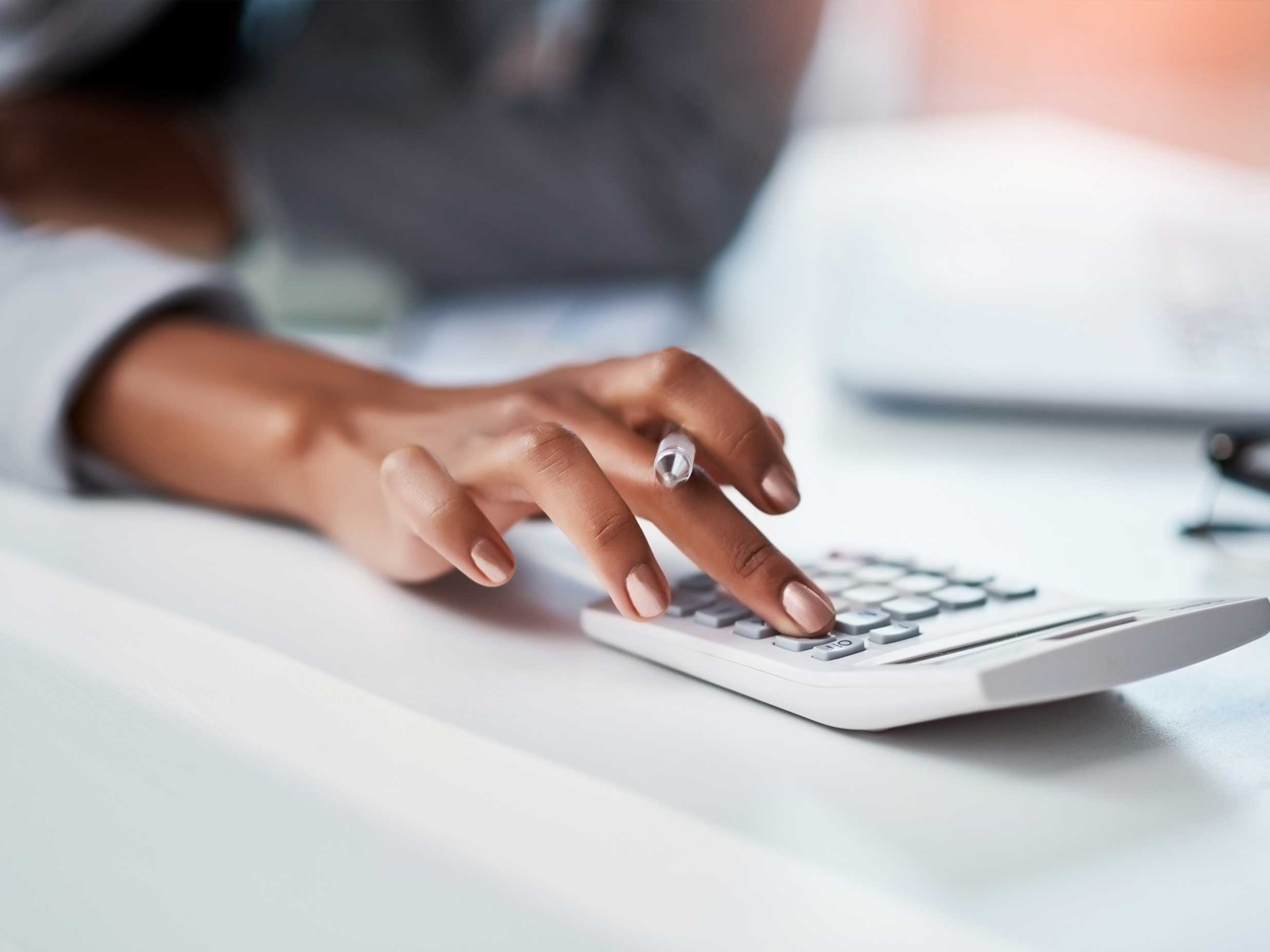 Person calculating business insurance costs.
